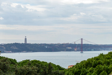 Fototapeta na wymiar Cristo-Rei or King-Christ Sanctuary in Almada with a view over the Tagus River and the 25 de Abril bridg, Lisbon, Portugal