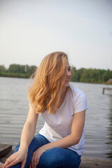 Fototapeta na wymiar Beautiful blonde girl near the river.