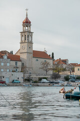Fototapeta premium Beautiful historic church with a picturesque belltower in Sumartin, on the island Brac in Croatia in winter time.
