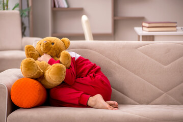 Young little girl staying at home alone