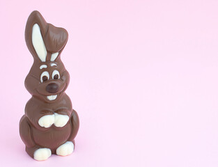 Easter chocolate bunny on a pink background. close-up. copy space. Minimalism. Easter concept.