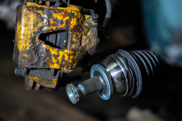 installation of the drive shaft of the joint and half shaft in the engine gearbox, a metal clamp on the rubber boot. - obrazy, fototapety, plakaty