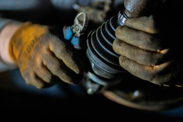installation of the drive shaft of the joint and half shaft in the engine gearbox, a metal clamp on...