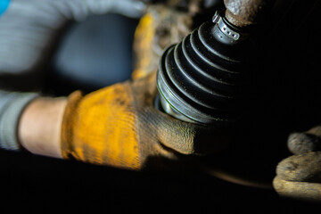 car drive shaft repair, CV joint and boot installation.