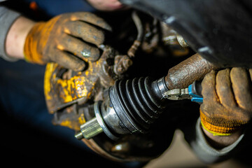 car drive shaft repair, CV joint and boot installation. - obrazy, fototapety, plakaty