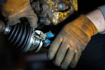 installation of the drive shaft of the joint and half shaft in the engine gearbox, a metal clamp on...