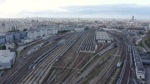 City famous train station rail ways aerial. Passenger Train Arriving On Station.  Train Station Aerial Drone. A drone flies over a train station. Aerial top view.