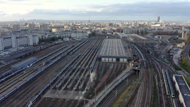 City famous train station rail ways aerial. Passenger Train Arriving On Station.  Train Station Aerial Drone. A drone flies over a train station. Aerial top view.