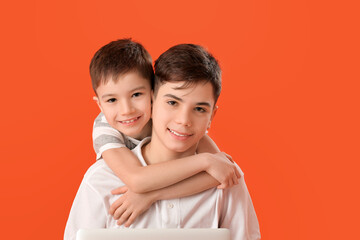 Portrait of cute brothers on color background