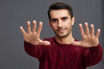 portrait man in a red sweater hand gesture posing self confidence cropped view