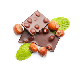 Pieces of tasty chocolate with hazelnuts on white background