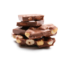 Pieces of tasty chocolate with hazelnuts on white background
