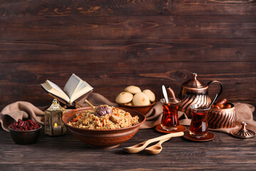 Traditional Eastern dishes with tea on wooden background