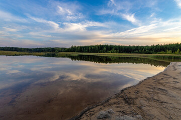 View of the lake on a summer evening. Landscape, peace, tranquility.