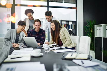 Working towards developing their skills together. Cropped shot of a group of businesspeople working...