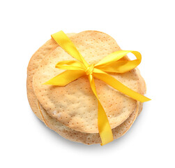 Jewish flatbread matza for Passover with yellow ribbon on white background