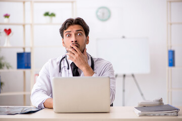 Young male doctor in telemedicine concept