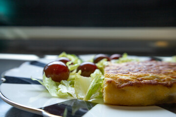 Delicious Spanish food,  omelette with green salad ready to eat. Mediterranean diet.