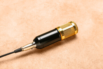 New modern microphone with wire on color background