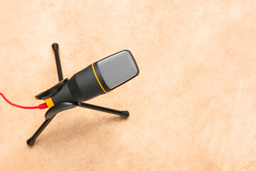 Modern microphone with stand on color background