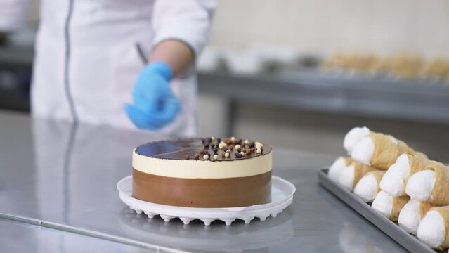 Pastry making cake proccess. Professional confectioner prepairing sweet candies.