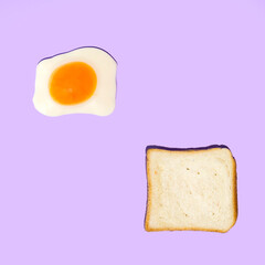 Creative pattern of eggs and bread on a pastel purple background. Retro trendy aesthetic food concept from the 80s or 90s. Minimal idea for breakfast.