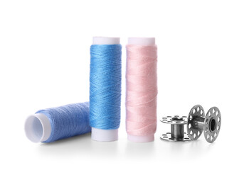 Different thread spools on white background