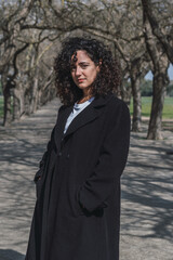 Naklejka premium Portrait of a young woman smiling in a coat