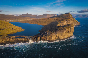 Obraz premium Panoramic aerial View Of The Traelanipan Cliff And Sorvagsvatn Lake at Sunny Day, Vagar, Faroe Islands, Denmark. A Lake Above the Ocean. November 2021