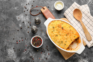 Baking dish with tasty Shepherd's pie on dark background
