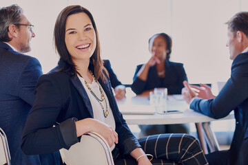 This is the team you wanna be on. Cropped portrait of a businesswoman sitting in the boardroom with her colleagues.