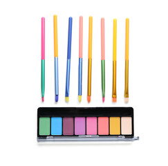 Naklejka premium Rainbow palette of eyeshadows and makeup brushes isolated on white