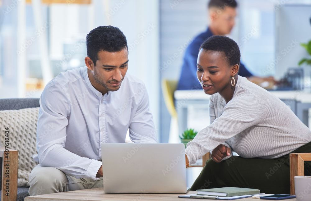 Poster id go with this one. shot of two businesspeople discussing something on a laptop while sitting toget