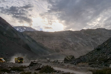 A mining truck driving on a gravel road in the Andes Mountains, close to Santiago, Chile.