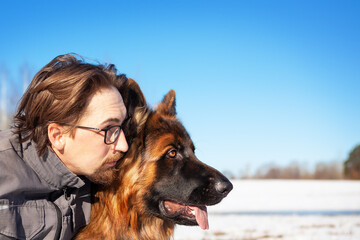 Portrait of a man with his German Shepherd dog.