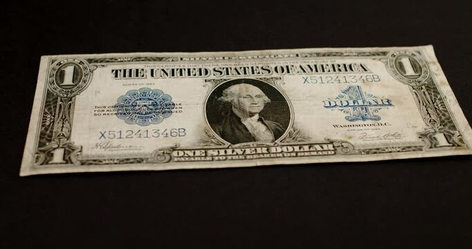 Rare old historic silver certificate Dollar banknote on dark background. Inflation in the United States of America