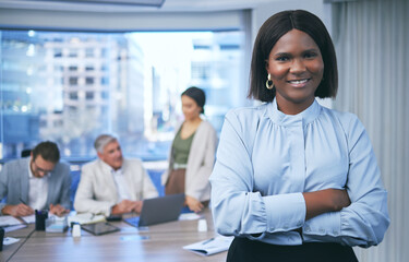 Stay focused and keep it moving. Shot of a beautiful businesswoman standing in a boardroom during a meeting.