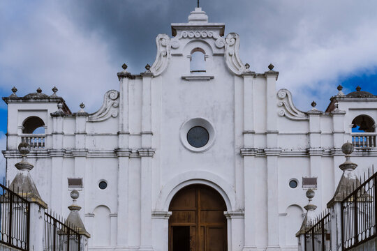 Church in Apaneca, El Salvador. White old church with arched door. Christian house of worship