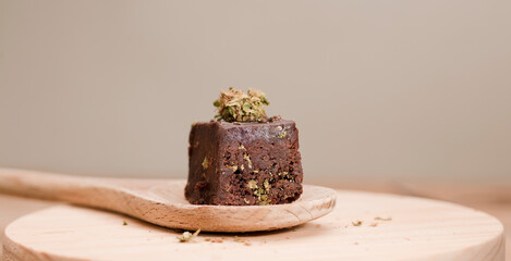 marijuana brownie on wooden spoon on kitchen table