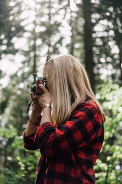 Female Photographer In Forest.