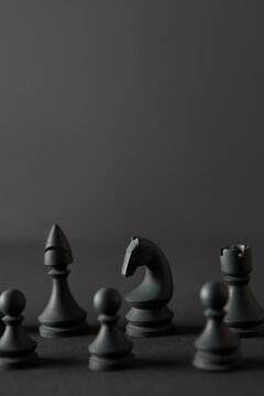 Set from black chess figures on dark background.