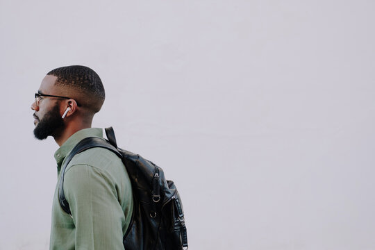 Side view of stylish man with white wall.