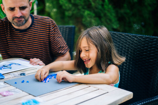 Happy girl with father playing game