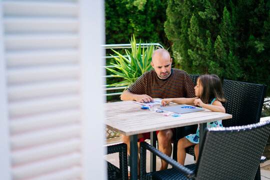 Daughter with father collecting game pieces