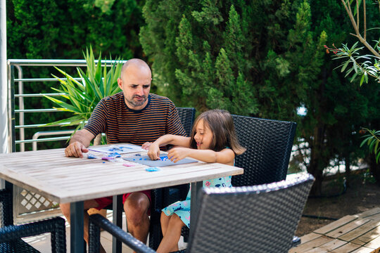 Daughter with dad playing tabletop game