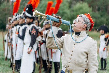  White mature male soldier plays the trumpet.
