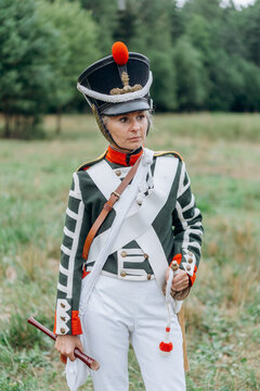 A woman soldier holds a flute in her hands