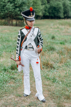A woman soldier holds a flute in her hands