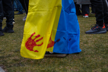 Berlin, Germany Peaceful protest against the war and genocide in Ukraine, handprints in blood on the Ukrainian flag