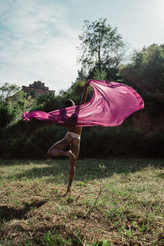 Portrait of expressive male dancer in nature jumping and moving